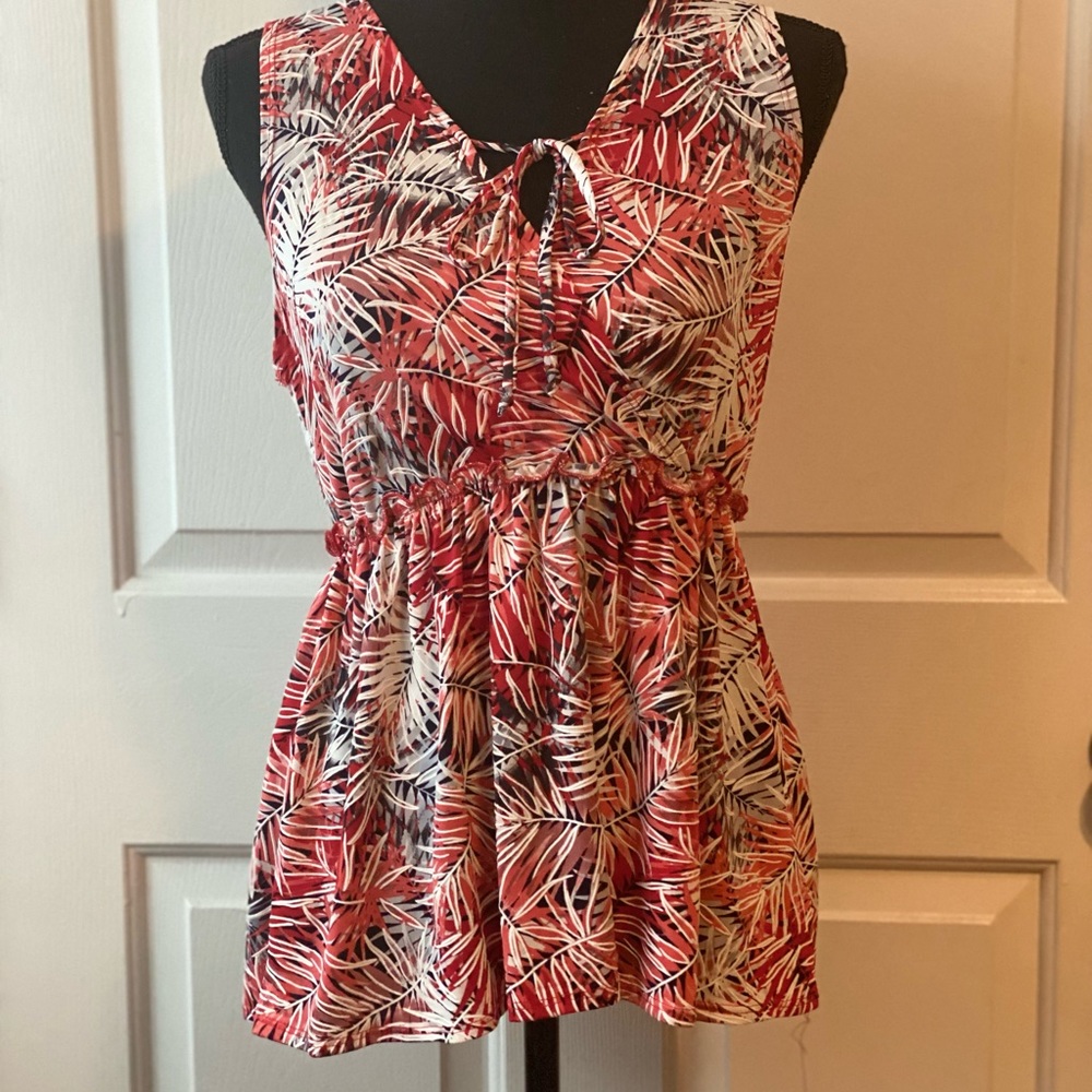 Red, black, and white patterned blouse.